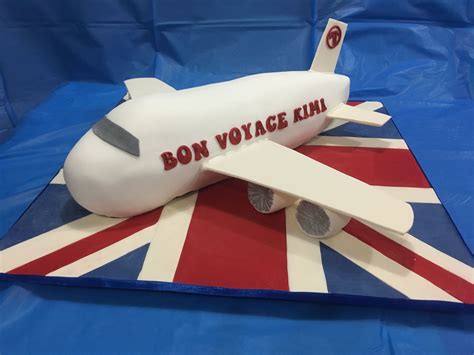 A Cake Made To Look Like An Airplane With The Words Bon Voyage Kui On It