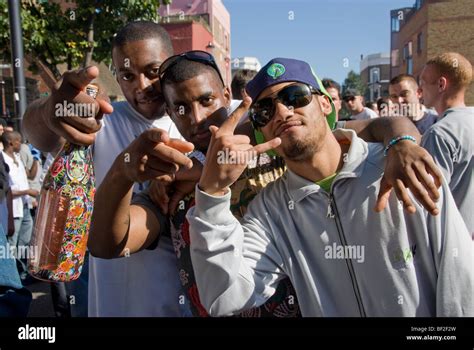 Three Young Men Using Hip Hop Or Gangsta Gestures In Streets Of Notting