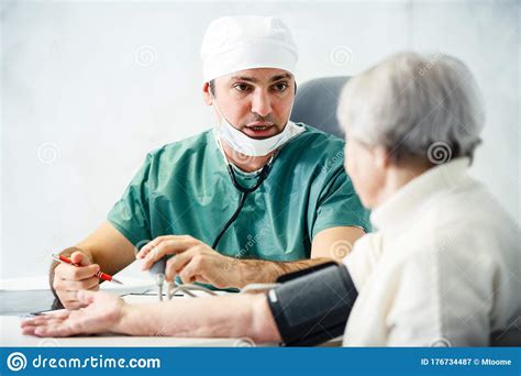 Healthcare In Hospital Concept Male Doctor Consulting Old Lady Stock