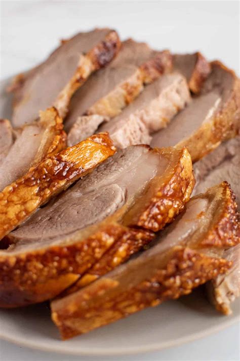 This roast pork loin recipe calls for rubbing a boneless pork loin with a simple blend of garlic and fresh herbs before roasting it to perfection. Air Fryer Pork Roast with Crispy Crackling | Hint of Healthy