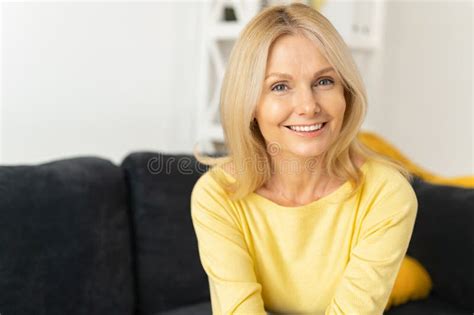 Senior Woman In Home Interior Charming Mature Caucasian Lady Looking At The Camera And Laughing