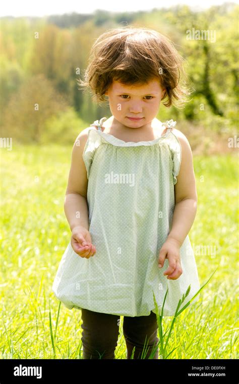 Little Girl Standing In Meadow Portrait Stock Photo Alamy