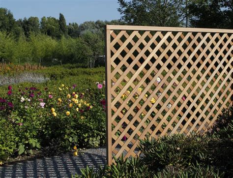 A Wooden Trellis In The Middle Of A Flower Garden