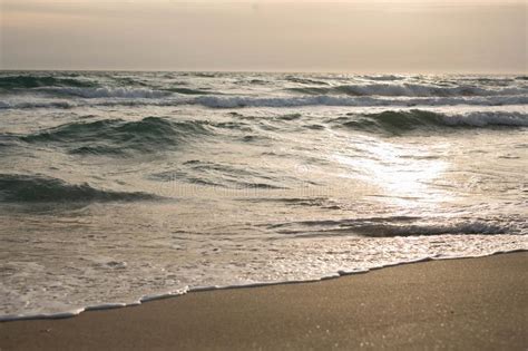 Waves Of The Blue Sea Splashing On The Sandy Shore Stock Photo Image