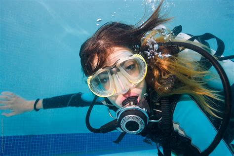 Portrait Of A Beautiful Woman Scuba Diving Underwater In The Swimming