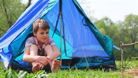 Boy With Bare Feet Sits In Blue Tent At Summer Forest Stockfootage En