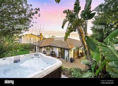 A backyard oasis featuring a luxurious hot tub nestled beside a