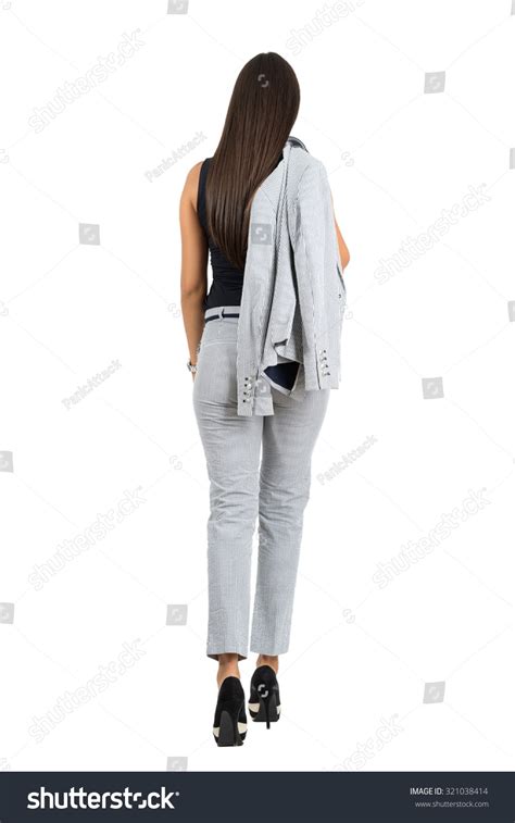 Rear View Of Business Woman In Formal Wear Holding Jacket Walking Away