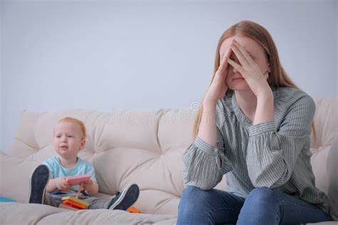 Depressed Single Mother With Child In Living Room Stock Photo Image
