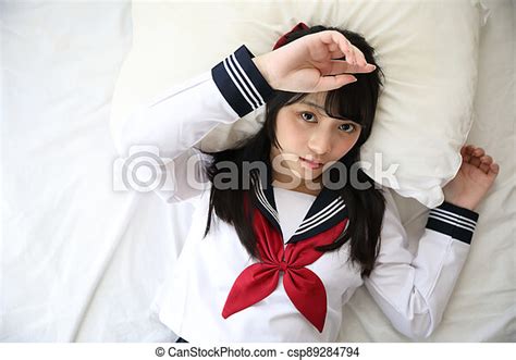 portrait japanese school woman sleeping in white tone bed room portrait japanese school woman
