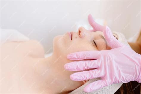 Premium Photo Face Massage Closeup Of A Young Woman Receiving A Spa Massage In A Beauty Salon