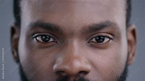 Close Up Of Beautiful Black Man Eyes Staring At Camera Portrait Detail Of Serious Confident