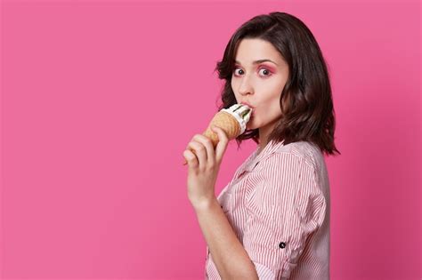 Premium Photo Sideways Shot Of Brunette Lady Licks Ice Cream Has