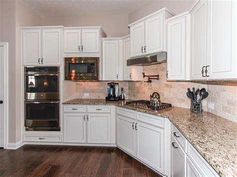 Pot fillers or pot filler faucets are a very handy addition to the kitchen. Note the gas cooktop and double ovens, and oh wait, the ...