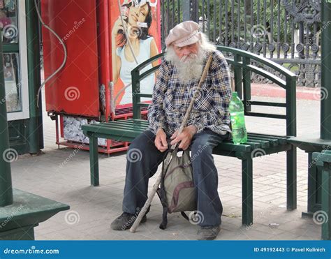 Senior Adult Man Sitting On The Bus Stop Bench Editorial Stock Photo
