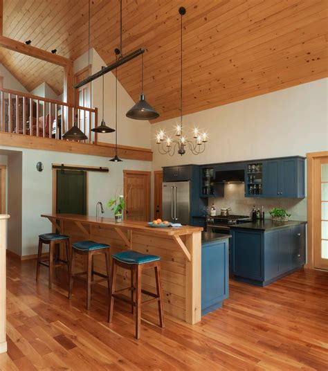 Here again, the tall sloped ceiling does its thing, the hood and chimney rises to the top, but the kitchen cabinets stay at the same height. cabinets to ceiling with sloped and exposed beams
