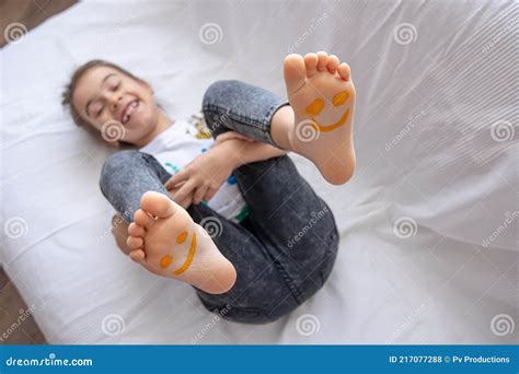 Close Up Of Little Girl S Feet Painted With Smiles Stock Photo Image