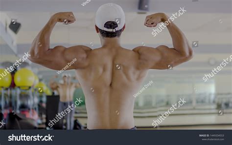 Man Flexing Back Muscles Bodybuilding Pose Stock Photo 1449334553