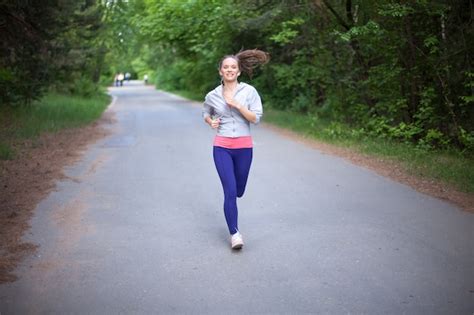 Free Photo Happy Young Woman Jogging And Smiling In Park