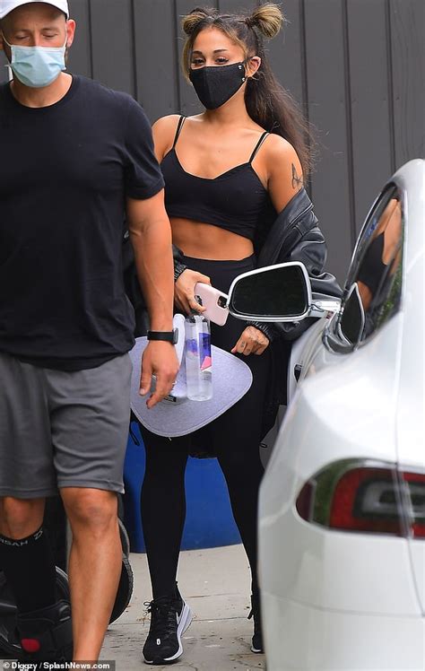 ariana grande showcases her toned abs in a sports bra and leggings after a workout in la