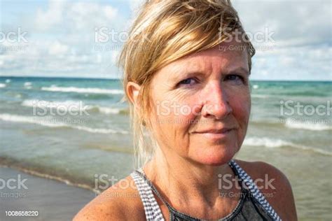 Portrait Of A Pretty Woman In Her Fifties On A Beach Stock Photo