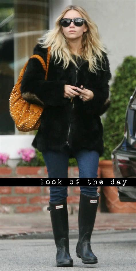 Ashley Olsen In A Black Fur Coat Denim And Rain Boots Style Fashion
