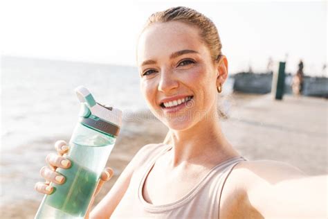 Sports Woman Outdoors On Beach Take A Selfie By Camera Stock Photo