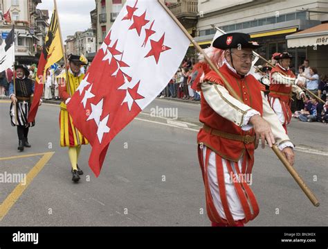 Men In Traditional Swiss Costumes Carry Region Flags Parade Interlaken