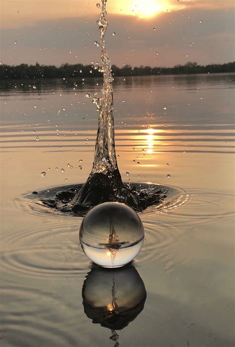 An Object Floating On Top Of Water In The Middle Of A Lake With Sun