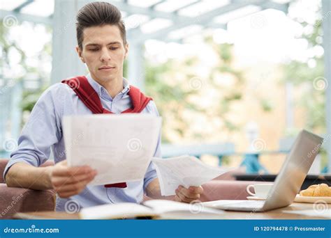 Young Man Reading Papers Stock Photo Image Of Corporate 120794478
