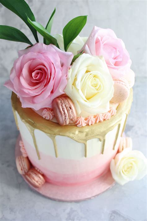 Pink Ombré Cake With A Hand Painted Gold Drip Topped With Pink And
