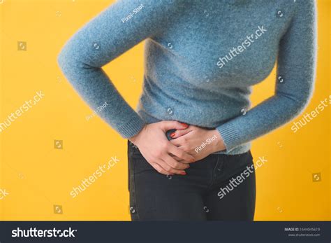Young Woman Suffering Abdominal Pain On Stock Photo 1644045619