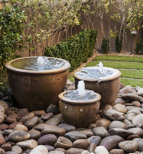 This lovely fountain is constructed from a strawberry planter. All About Garden Fountains | Garden fountains, Courtyard ...