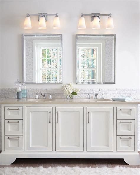 In this bath, the combination of overhead light from the chandelier, natural light from the windows, and light from the fixtures above the mirrors covers all of the lighting needs. 20 On-Trend Bathroom Lighting Ideas for 2020 | 1StopLighting