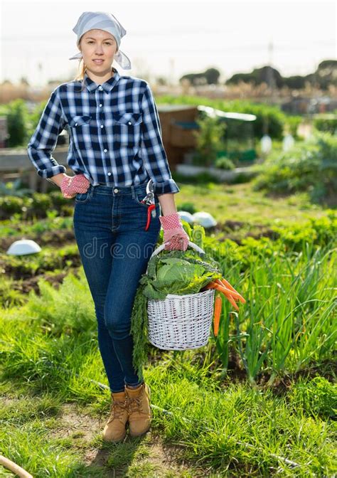 Girl Farmer With A Basket Of Vegetables In The Garden Stock Photo