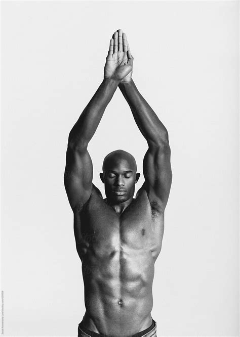 Black And White Portrait Of Strong African Male Posing In Studio By