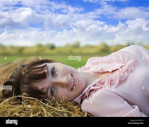 Girl Resting On Fresh Hay Bale Stock Photo Alamy