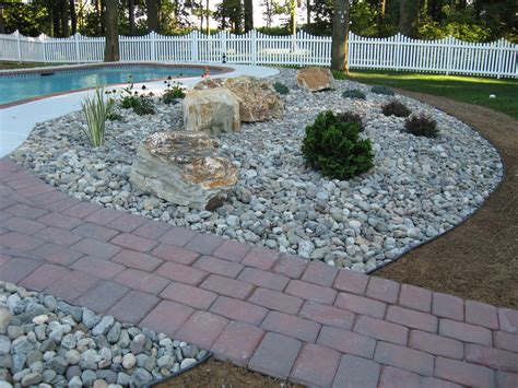 River Stones And Boulders With Poolside Plantings Landscaping With