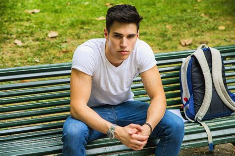 Young Male Student Sitting On Park Bench Seriously Stock Image Image