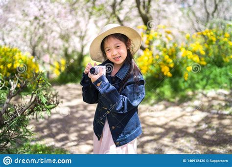 Asian Child Holding Camera Taking Photo On Travelling Trip During