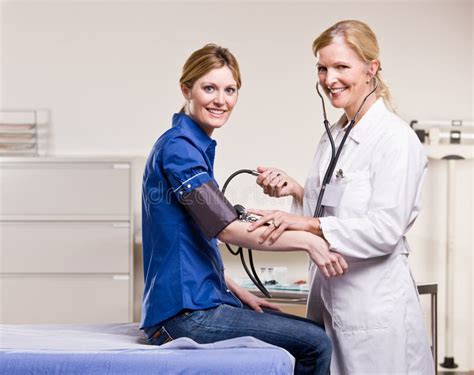 Doctor Checking Woman Blood Pressure Stock Photo Image Of Middle