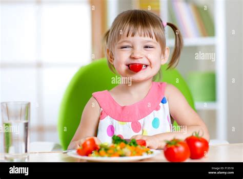 Kid Girl Eating Healthy Vegetables Stock Photo Alamy