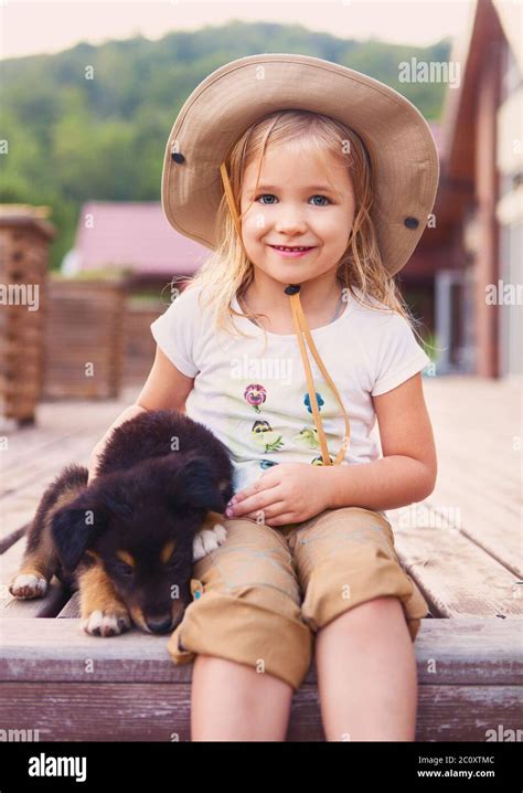 Cute Little Girl Hugging Dog Puppy Stock Photo Alamy