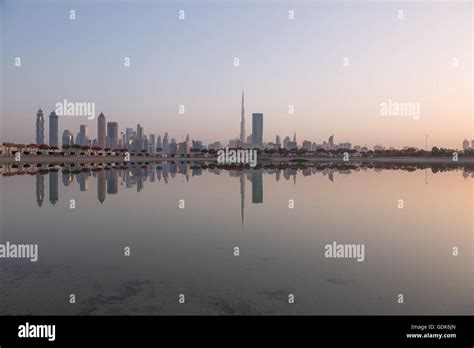 Dubai Downtown And Business Bay Skyline Sunrise Reflection Stock Photo