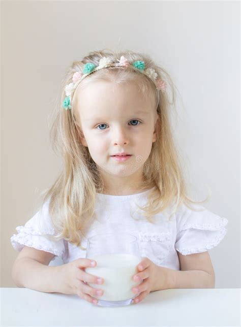 Little Blond Girl Drink A Glass Of Milk With Different Emotions Stock