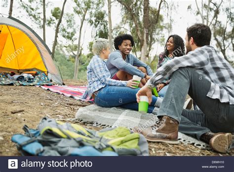 Friends Talking While Camping Outdoors Stock Photo Alamy