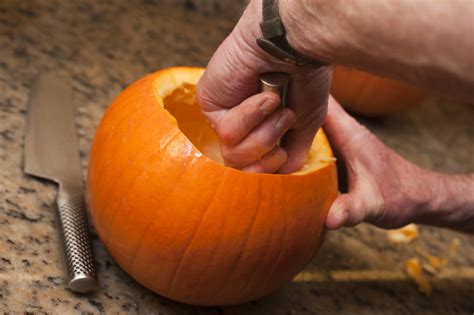 Image Of Man Hollowing Out A Pumpkin Creepyhalloweenimages