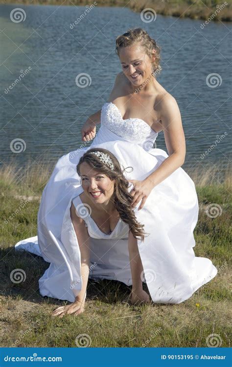 just married happy lesbian couple in white dress has fun near sm stock image image of love