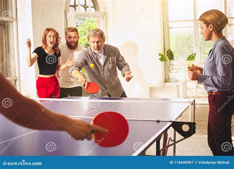 Group Of Happy Young Friends Playing Ping Pong Table Tennis Stock Image