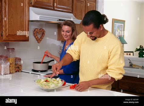 Man And Woman Cook Dinner And Enjoy Each Other Friendship Friends
